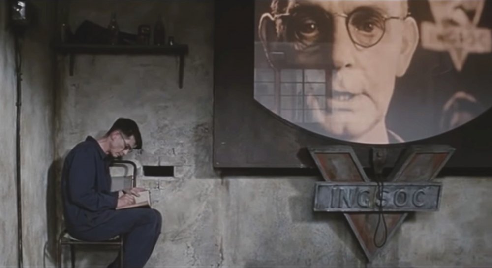 nineteen eighty four 1984 004 john hurt book against enlarged face screen reverse